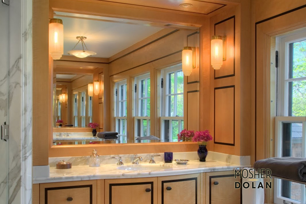 Large transitional master bathroom photo in Detroit with an integrated sink, flat-panel cabinets, light wood cabinets, marble countertops and beige walls