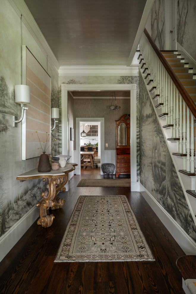 Design ideas for a large victorian hallway in Houston with dark hardwood flooring, brown floors and wallpapered walls.