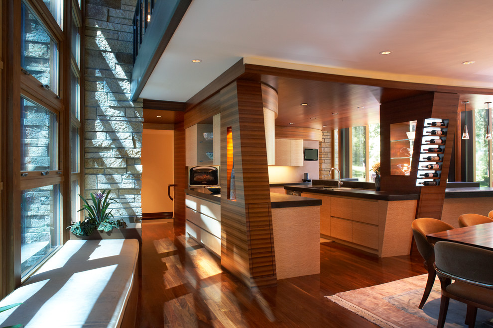 Example of a trendy eat-in kitchen design in Minneapolis with flat-panel cabinets, medium tone wood cabinets and concrete countertops