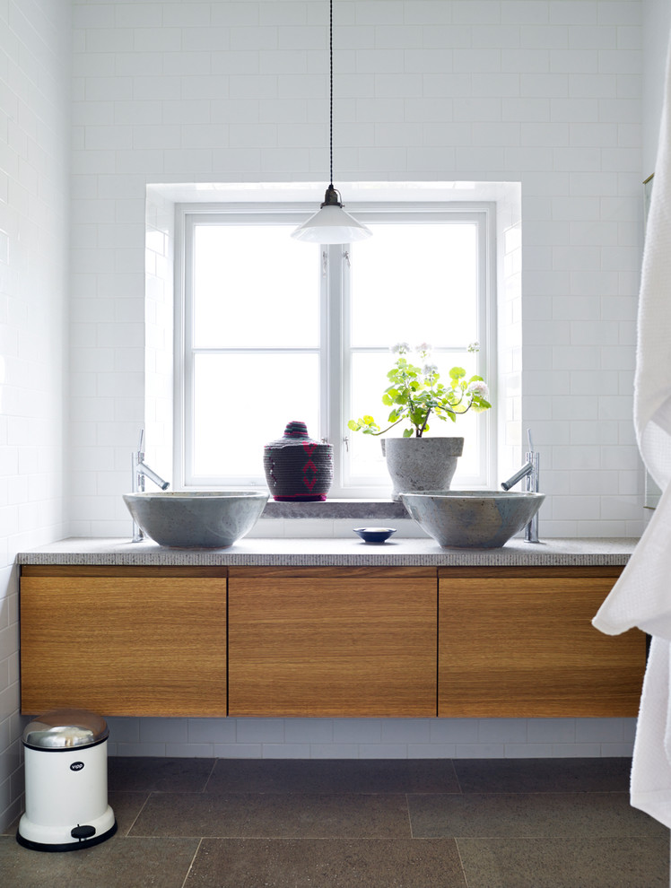 Design ideas for a mid-sized asian bathroom in Stockholm with flat-panel cabinets and medium wood cabinets.