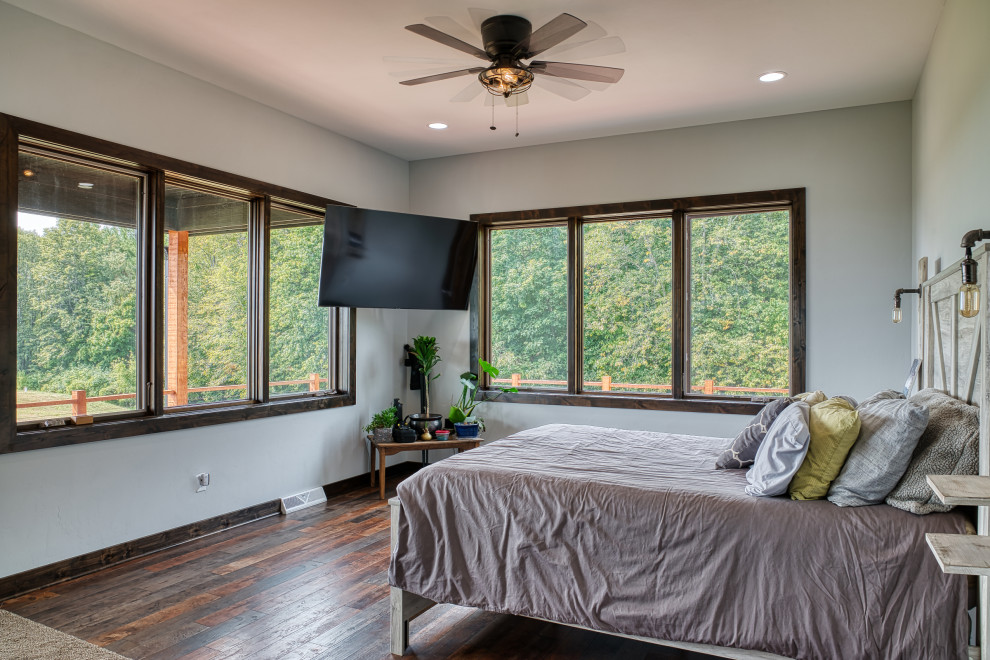 Diseño de dormitorio campestre de tamaño medio con paredes blancas, suelo de madera oscura y suelo marrón