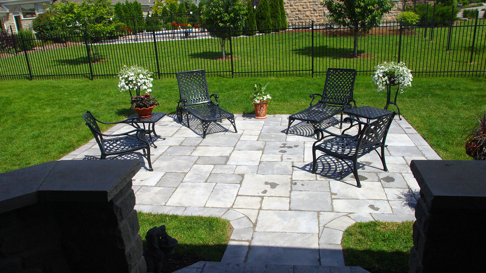 Photo of a mid-sized traditional backyard patio in Toronto with concrete pavers and no cover.