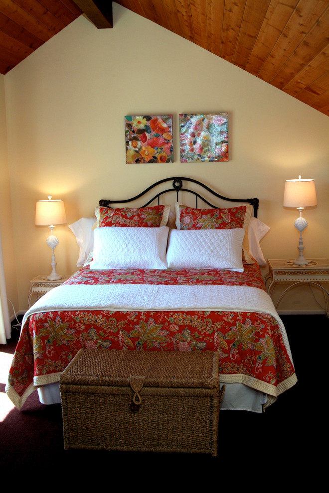 Photo of a mid-sized country guest bedroom in Orange County with beige walls, carpet, no fireplace and red floor.