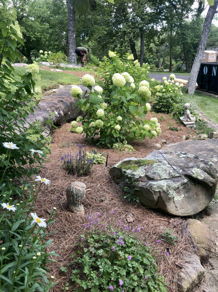 Photo of a large traditional partial sun landscaping in Other.