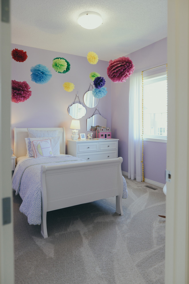 This is an example of a mid-sized traditional kids' bedroom for kids 4-10 years old and girls in Calgary with purple walls, carpet and grey floor.