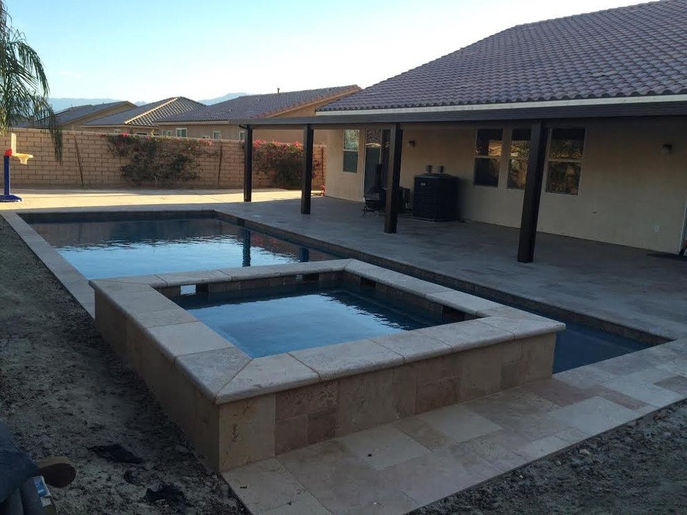 Hot tub - mid-sized backyard concrete paver hot tub idea