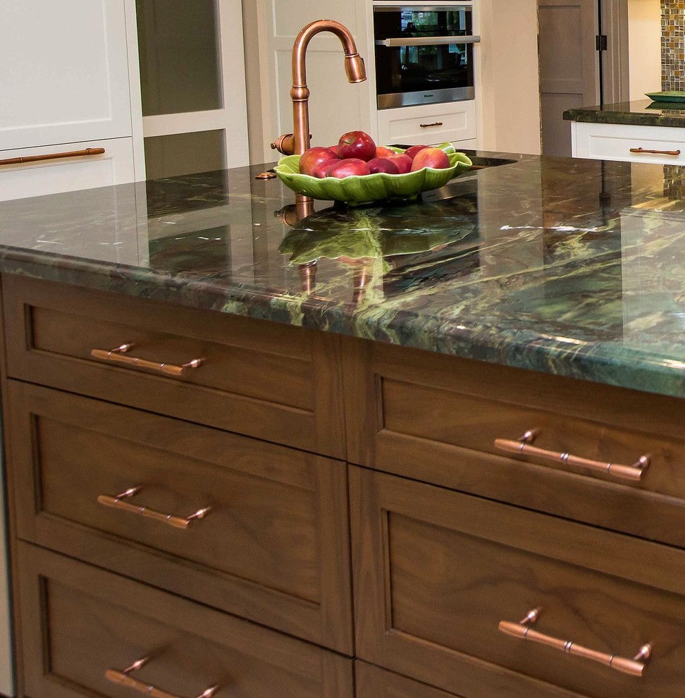 Open concept kitchen - large transitional u-shaped light wood floor open concept kitchen idea in Miami with a farmhouse sink, shaker cabinets, stainless steel appliances, an island, white cabinets, granite countertops, metallic backsplash and mosaic tile backsplash
