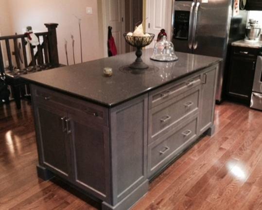 Example of a mid-sized transitional medium tone wood floor kitchen design in Toronto with shaker cabinets, gray cabinets, quartz countertops, stainless steel appliances and an island