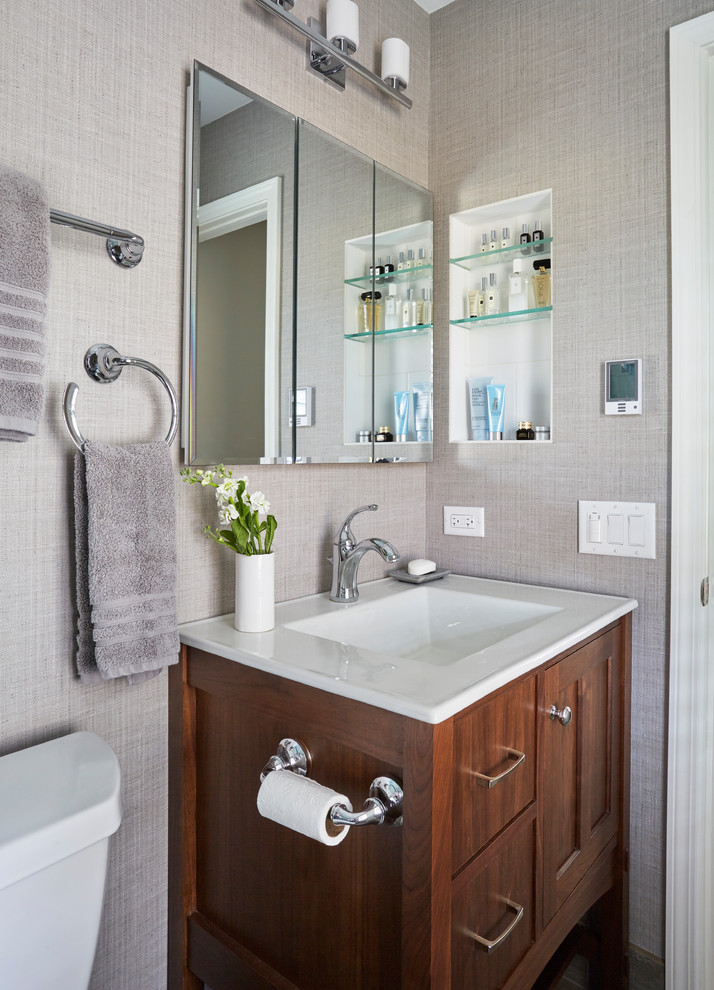 Photo of a small transitional master bathroom in Chicago with shaker cabinets, brown cabinets, an alcove shower, a two-piece toilet, white tile, ceramic tile, beige walls, porcelain floors, an integrated sink, brown floor, a sliding shower screen and white benchtops.