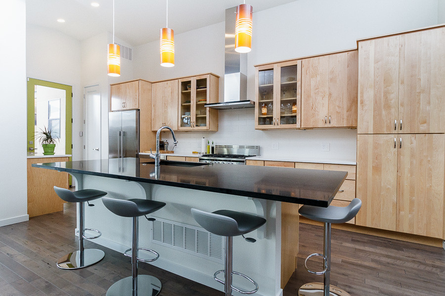 Design ideas for a mid-sized midcentury galley open plan kitchen in Denver with a drop-in sink, flat-panel cabinets, light wood cabinets, white splashback, dark hardwood floors, with island, stainless steel appliances and brown floor.