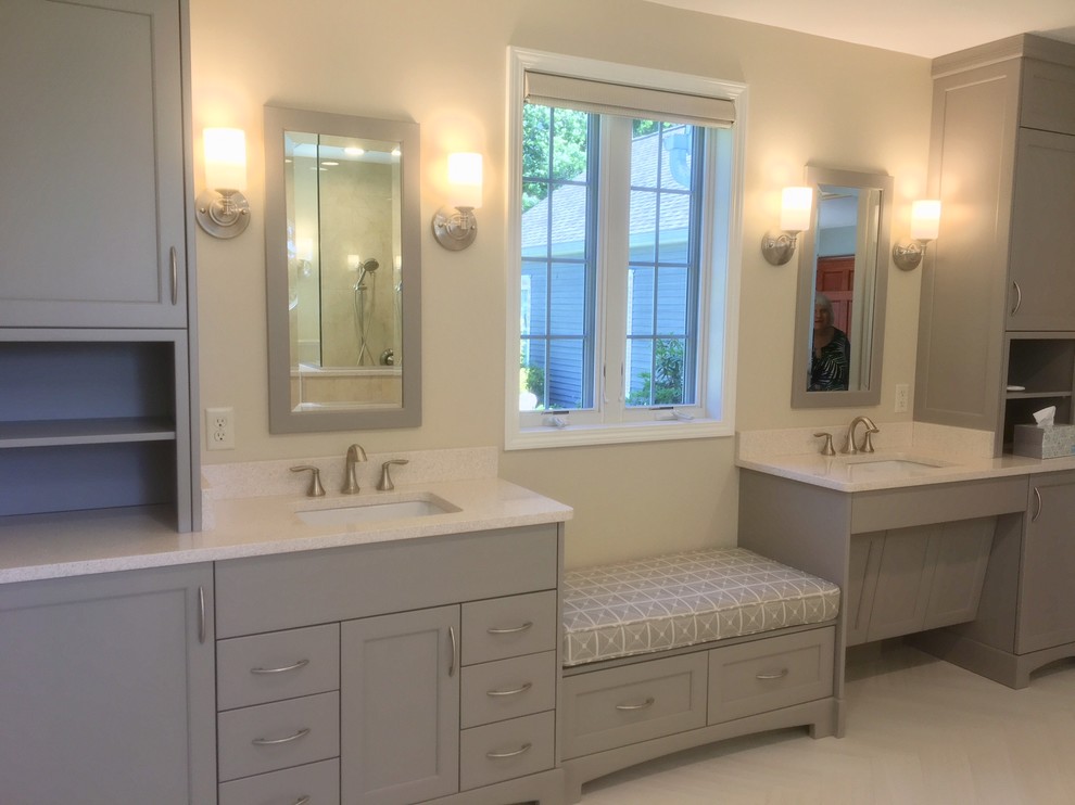 This is an example of a mid-sized contemporary master bathroom in New York with flat-panel cabinets, beige cabinets, an alcove tub, a curbless shower, a two-piece toilet, beige tile, porcelain tile, beige walls, porcelain floors, an undermount sink, engineered quartz benchtops, white floor, a hinged shower door and white benchtops.
