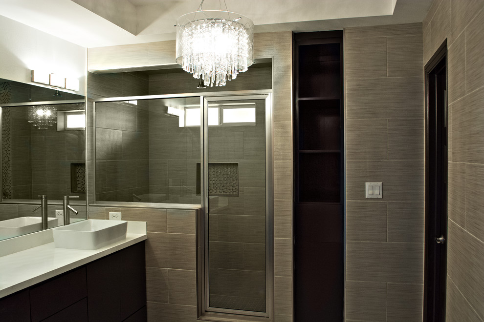 Example of a mid-sized transitional beige tile and porcelain tile porcelain tile corner shower design in Austin with a vessel sink, flat-panel cabinets, dark wood cabinets and quartzite countertops