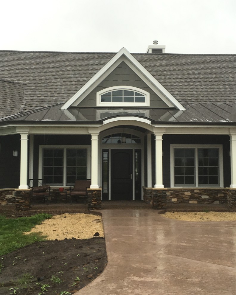 Example of a mid-sized transitional concrete floor front door design with gray walls and a dark wood front door