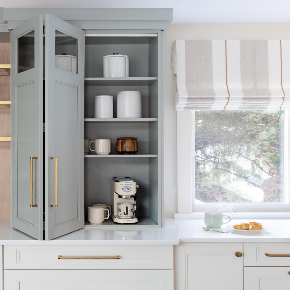 Inspiration for a large transitional l-shaped dark wood floor and brown floor enclosed kitchen remodel in New York with a farmhouse sink, recessed-panel cabinets, blue cabinets, marble countertops, white backsplash, stainless steel appliances, an island and white countertops