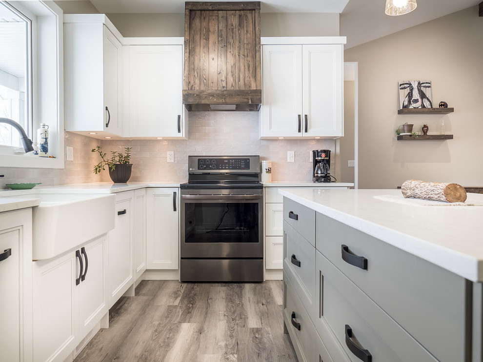 Inspiration for a large transitional u-shaped vinyl floor and multicolored floor eat-in kitchen remodel in Edmonton with a double-bowl sink, recessed-panel cabinets, white cabinets, quartzite countertops, white backsplash, ceramic backsplash, stainless steel appliances and an island