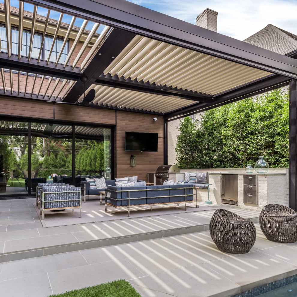 Large transitional backyard patio in Dallas with tile and a pergola.