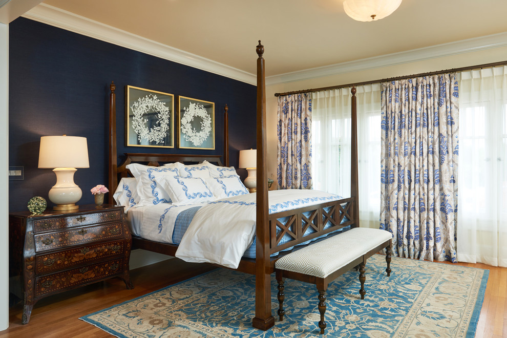 Inspiration for a traditional bedroom in Los Angeles with blue walls, medium hardwood floors and brown floor.