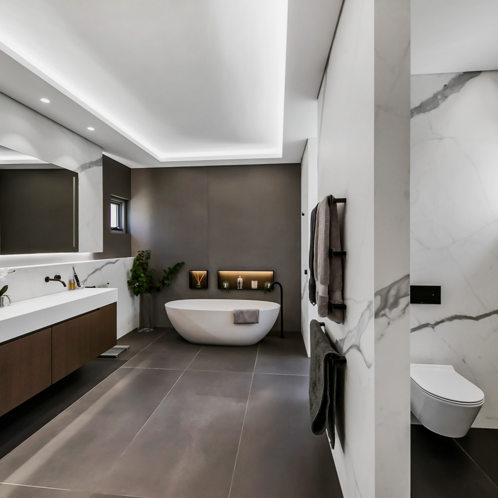 Inspiration for an industrial master bathroom in Perth with a freestanding tub, an open shower, a one-piece toilet, white tile, marble, grey walls, an integrated sink, engineered quartz benchtops, grey floor, an open shower, white benchtops, a niche, a single vanity and a floating vanity.