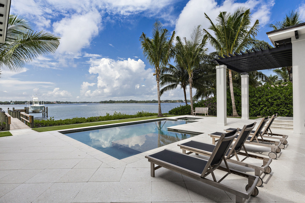 Transitional backyard l-shaped pool in Miami.