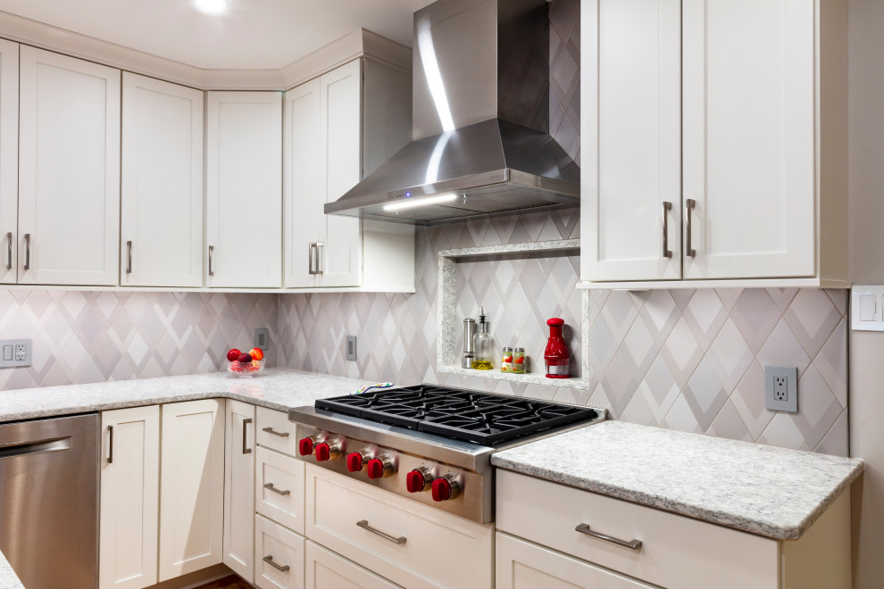 Example of a transitional kitchen design with shaker cabinets, quartz countertops and stainless steel appliances