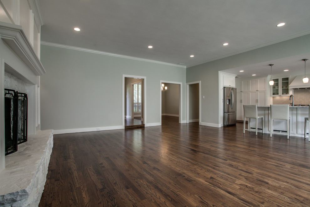 Home design - transitional open concept dark wood floor home design idea in Dallas with gray walls, a standard fireplace and a stone fireplace