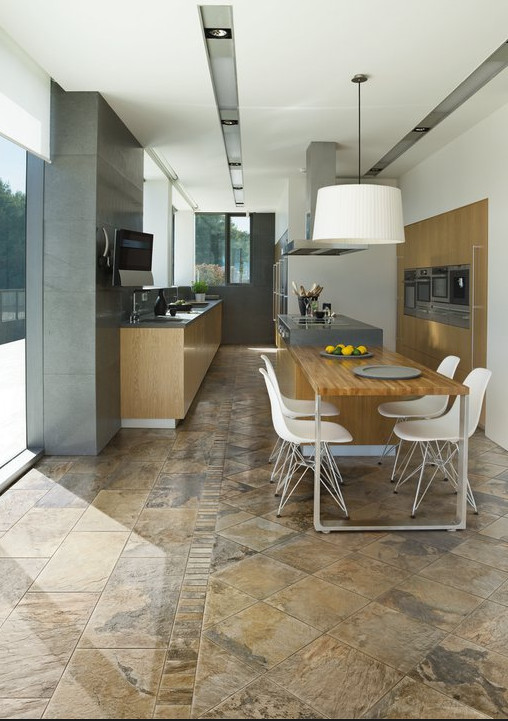 Eat-in kitchen - mid-sized transitional galley ceramic tile eat-in kitchen idea with flat-panel cabinets, light wood cabinets, stainless steel appliances and an island