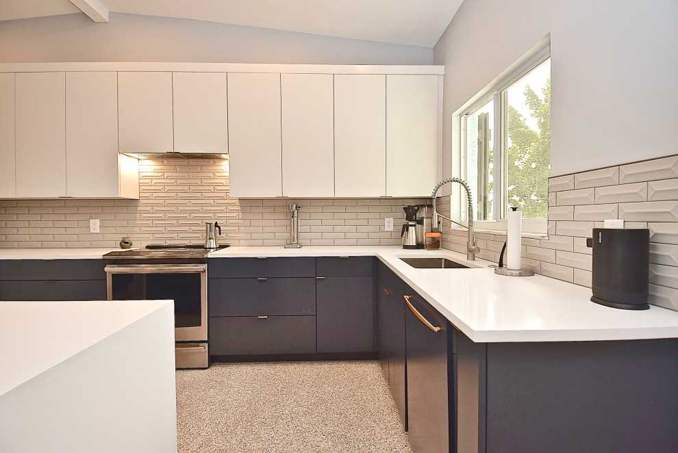 Large midcentury u-shaped kitchen in Tampa with a single-bowl sink, flat-panel cabinets, blue cabinets, quartz benchtops, grey splashback, ceramic splashback, stainless steel appliances, terrazzo floors, with island and white benchtop.