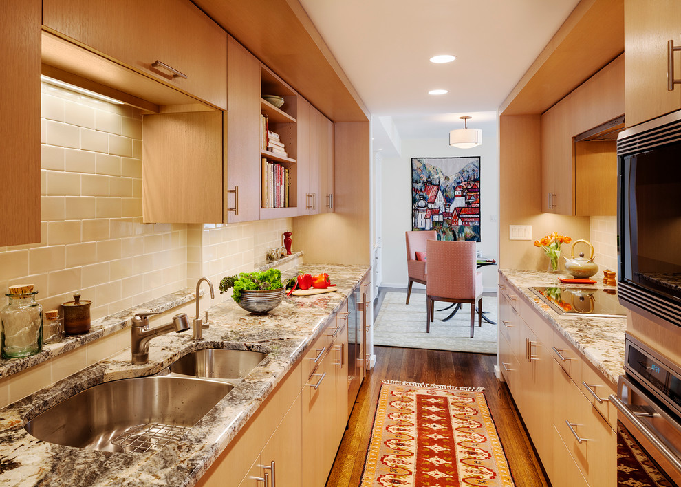 Transitional galley eat-in kitchen in Boston with an undermount sink, flat-panel cabinets, medium wood cabinets, granite benchtops, beige splashback, subway tile splashback and stainless steel appliances.