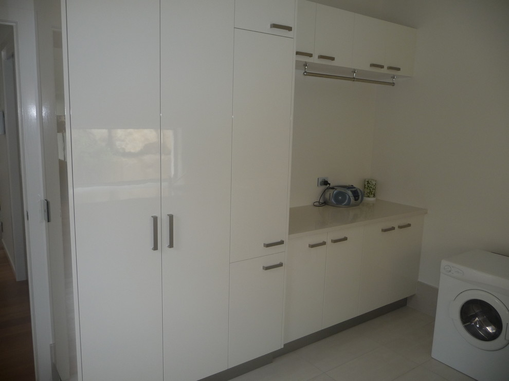 This is an example of a large modern laundry room in Brisbane.