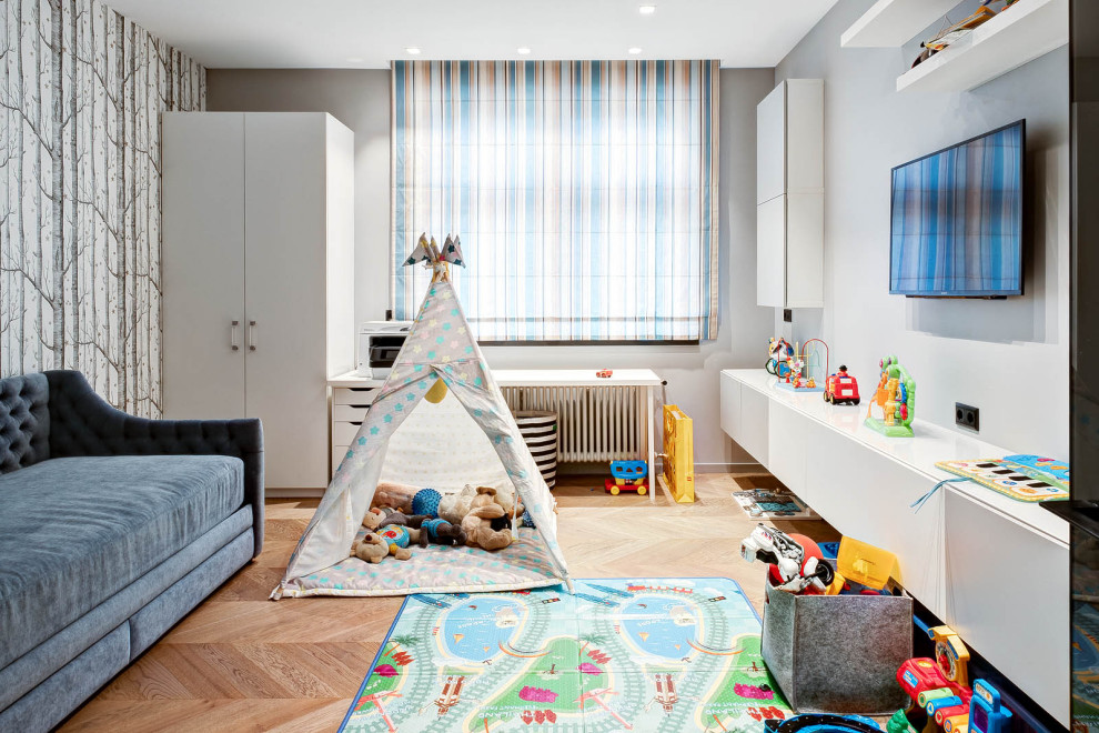 Inspiration for a contemporary gender-neutral kids' playroom for kids 4-10 years old in Moscow with grey walls, medium hardwood floors and brown floor.