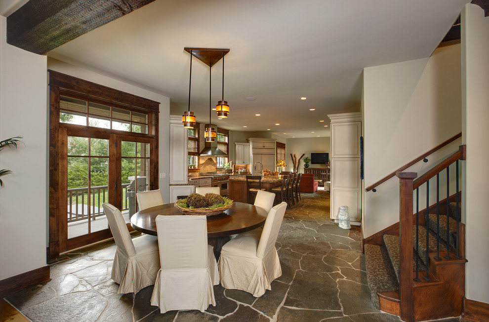 Design ideas for a country open plan dining in Chicago with slate floors, beige walls and no fireplace.