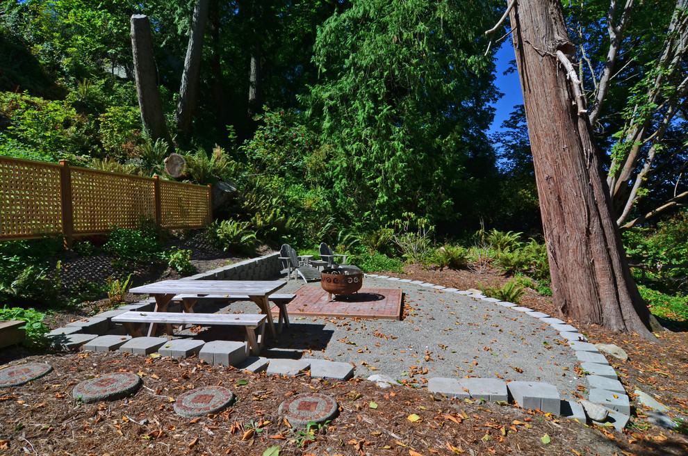 Design ideas for a mid-sized traditional backyard partial sun garden for summer in Seattle with a fire feature and brick pavers.
