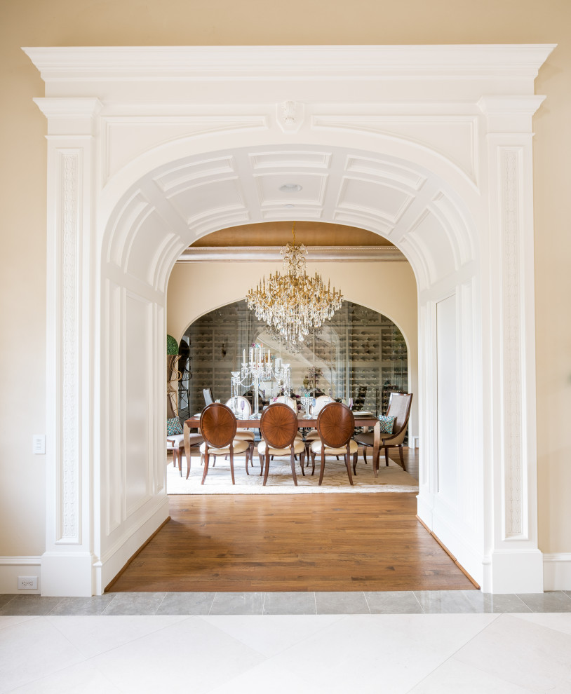 Expansive mediterranean separate dining room in Dallas with beige walls, medium hardwood floors, no fireplace and brown floor.