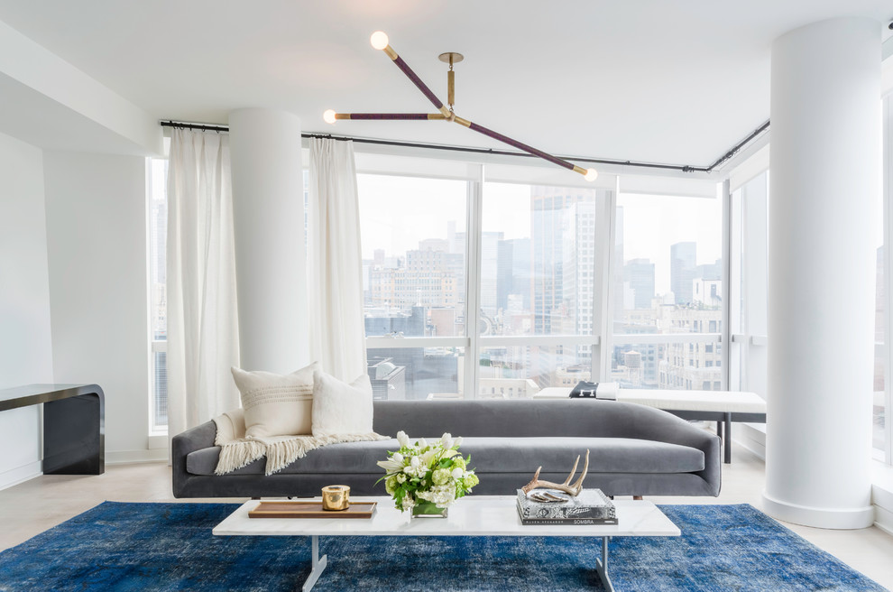Example of a large trendy formal and open concept beige floor living room design in New York with white walls, no fireplace and no tv