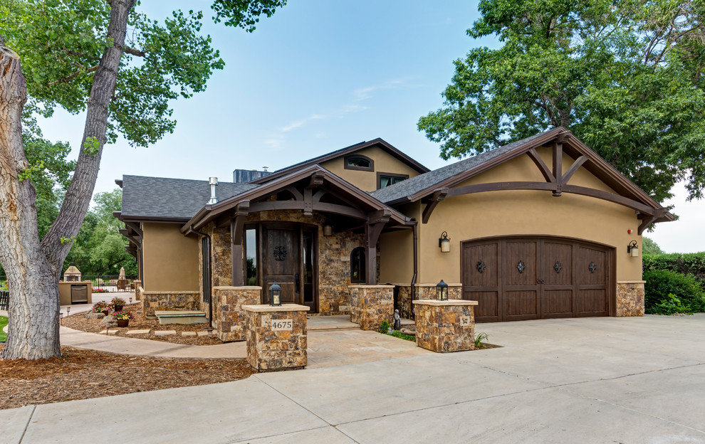 Inspiration for a mid-sized timeless beige three-story stucco gable roof remodel in Denver