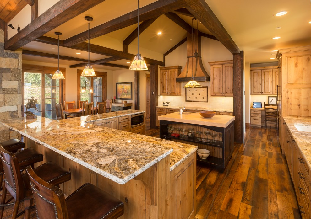 Inspiration for a large rustic u-shaped dark wood floor and brown floor eat-in kitchen remodel with raised-panel cabinets, granite countertops, paneled appliances, an undermount sink, light wood cabinets, two islands, beige backsplash and stone tile backsplash
