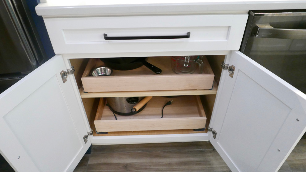 Example of a mid-sized transitional galley porcelain tile and gray floor eat-in kitchen design with an undermount sink, shaker cabinets, white cabinets, quartz countertops, white backsplash, subway tile backsplash, black appliances, no island and white countertops