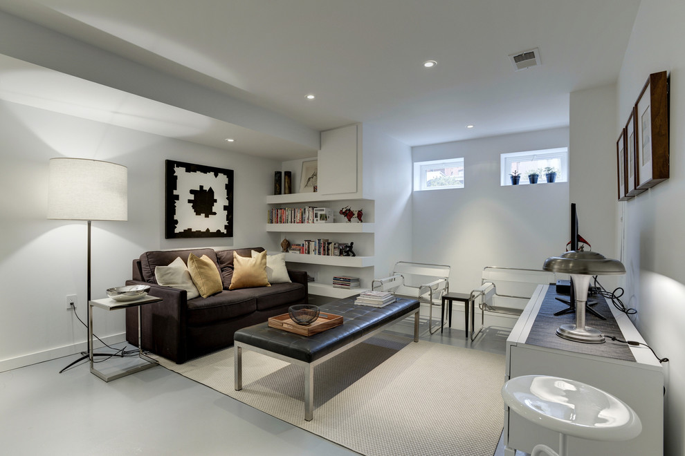 Photo of a mid-sized contemporary fully buried basement in DC Metro with white walls, concrete floors, no fireplace and grey floor.