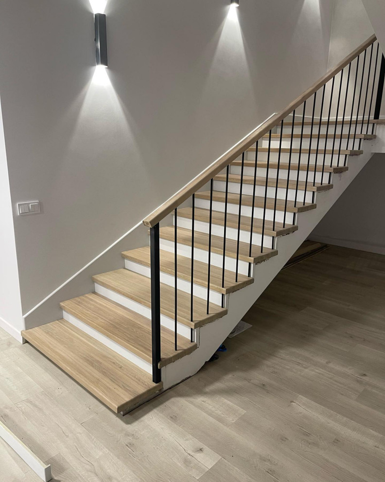 Photo of a medium sized modern wood straight metal railing staircase in Moscow with wood risers.