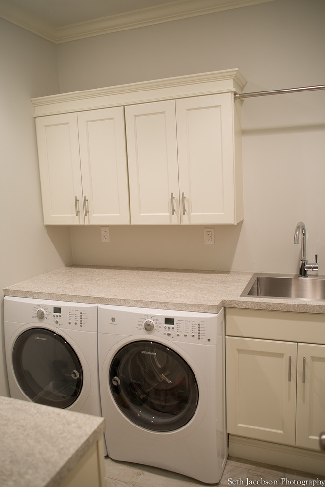 Design ideas for a small beach style galley utility room in Providence with a single-bowl sink, shaker cabinets, white cabinets, white walls and a side-by-side washer and dryer.