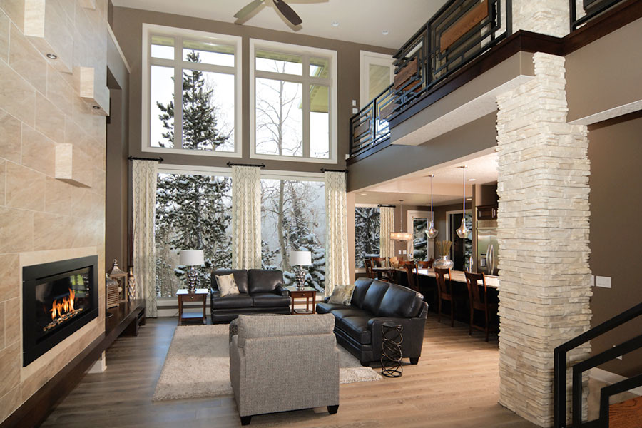 This is an example of a large contemporary formal open concept living room in Cincinnati with grey walls, light hardwood floors, a standard fireplace, a tile fireplace surround and beige floor.
