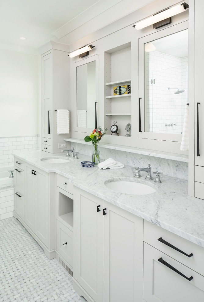 Photo of a mid-sized traditional master bathroom in Detroit with shaker cabinets, grey cabinets, a drop-in tub, a corner shower, a one-piece toilet, white tile, subway tile, white walls, marble floors, an undermount sink, engineered quartz benchtops, grey floor, a hinged shower door, grey benchtops, a shower seat, a double vanity and a built-in vanity.