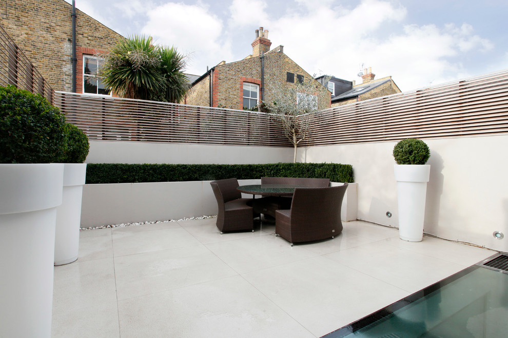Design ideas for a contemporary patio in London with no cover and tile.