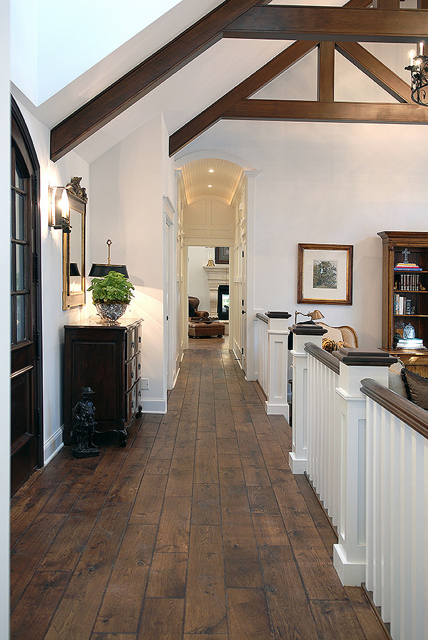 Design ideas for a large traditional hallway in Chicago with white walls, dark hardwood floors, brown floor and exposed beam.