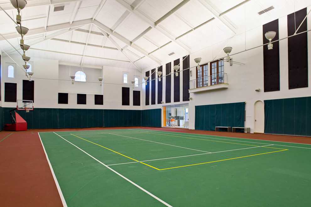 This is an example of an expansive mediterranean indoor sport court in Dallas with white walls.