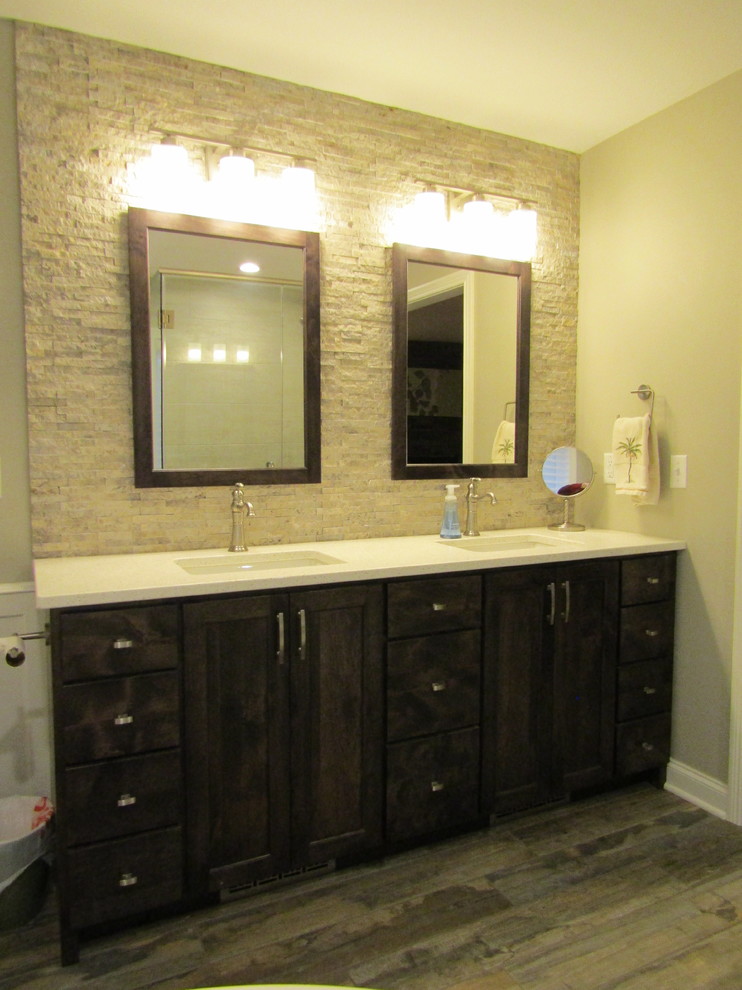 Mid-sized transitional master white tile and stone tile porcelain tile and brown floor freestanding bathtub photo with shaker cabinets, dark wood cabinets, gray walls, an undermount sink, granite countertops and a hinged shower door