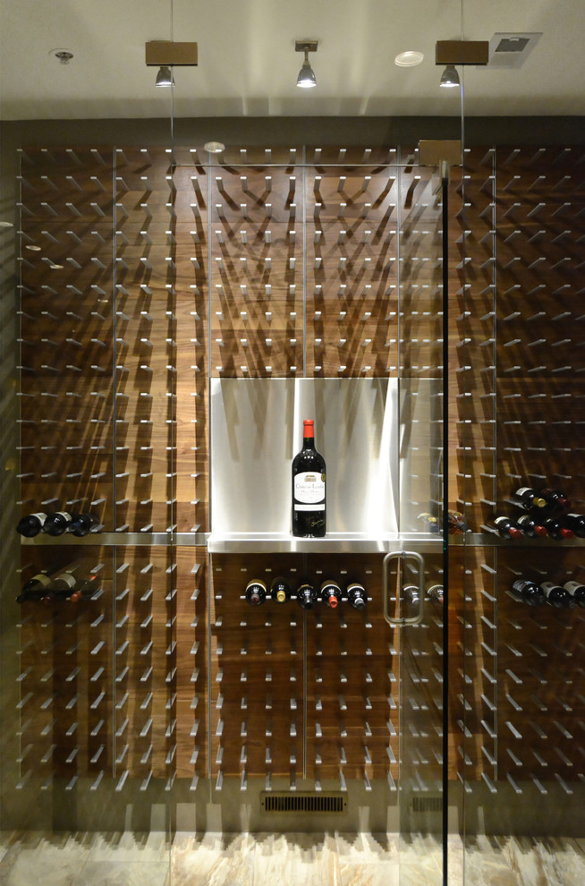 This is an example of a large contemporary wine cellar in Tampa with light hardwood floors and storage racks.