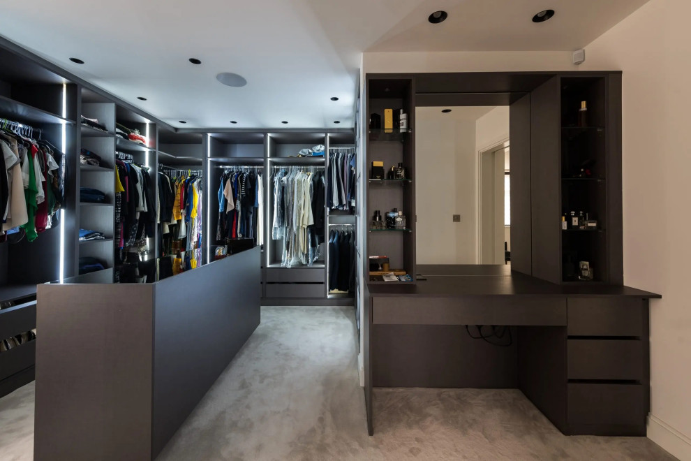 Photo of a small contemporary built-in wardrobe in London with feature lighting.