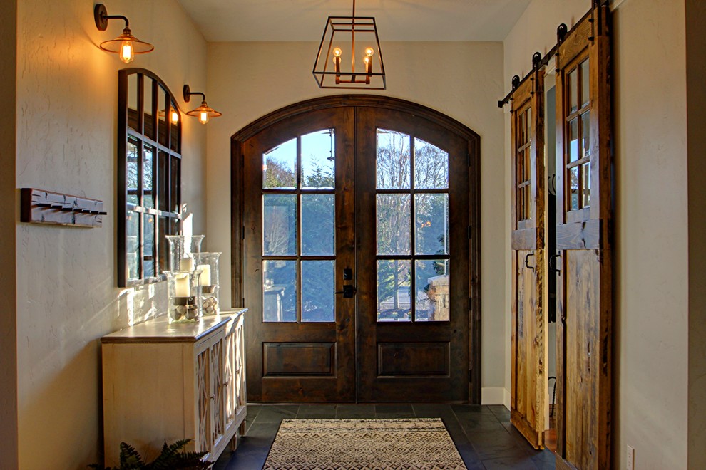Design ideas for a mid-sized country entry hall in Seattle with beige walls, slate floors, a double front door, a dark wood front door and grey floor.
