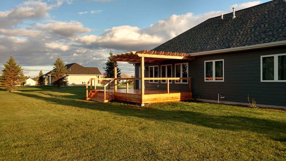 Example of a large mountain style deck design with a pergola